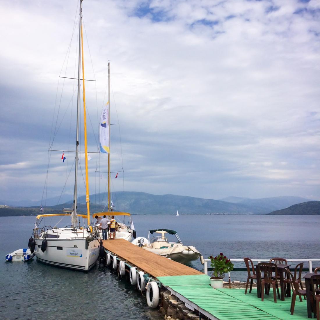 A sail boat on a quay.